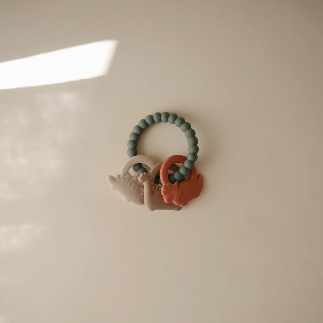 Mushie - Baby Beißring Silikon Dino